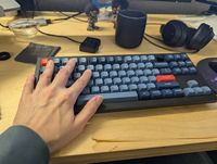 Keyboard with hand on it